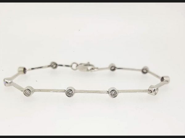 Diamond set Bar Bracelet; a delicate bar bracelet embracing bezel set round cut diamonds totaling 1.20 carats