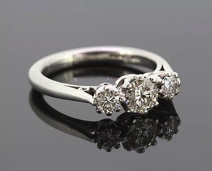 Diamond Three Stone Ring; A classic diamond trilogy ring, set with three round cut diamonds totaling 0.75 carats, eight-claw set, mounted in platinum.