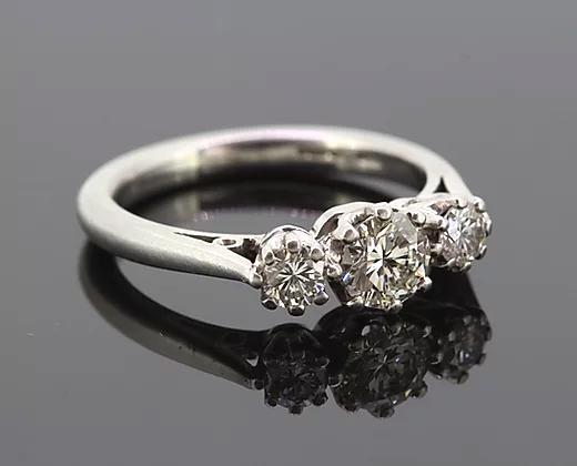 Diamond Three Stone Ring; A classic diamond trilogy ring, set with three round cut diamonds totaling 0.75 carats, eight-claw set, mounted in platinum.