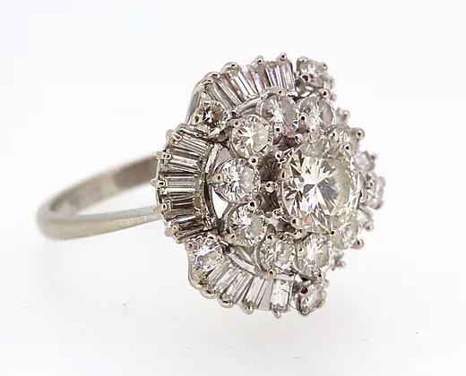 Vintage Diamond Cocktail Ring; central 1.80ct round cut diamond encircled by a double layer of 3.50cts round cut and baguette cut diamonds, 5.40 carat total, Circa 1960