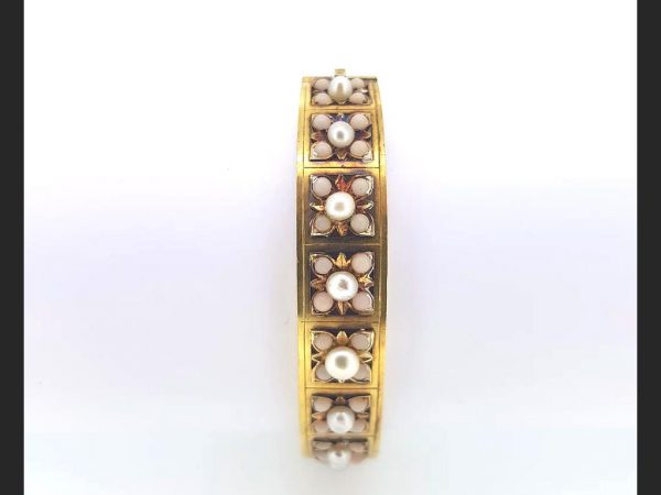 An Antique Victorian Natural Pearl and Angel Skin Coral Bangle, 15ct yellow gold. A statement piece