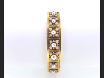 An Antique Victorian Natural Pearl and Angel Skin Coral Bangle, 15ct yellow gold. A statement piece