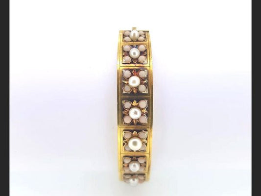 An Antique Victorian Natural Pearl and Angel Skin Coral Bangle, 15ct yellow gold. A statement piece