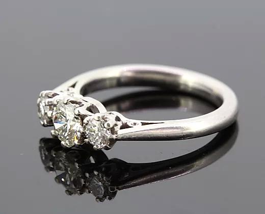 Diamond Three Stone Ring; A classic diamond trilogy ring, set with three round cut diamonds totaling 0.75 carats, eight-claw set, mounted in platinum.