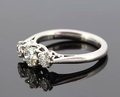 Diamond Three Stone Ring; A classic diamond trilogy ring, set with three round cut diamonds totaling 0.75 carats, eight-claw set, mounted in platinum.