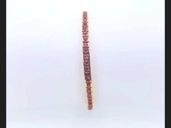 Pink Sapphire Line Bracelet; Princess cut pink sapphires totaling 5ct set into 18ct yellow gold line bracelet, 17.7g.