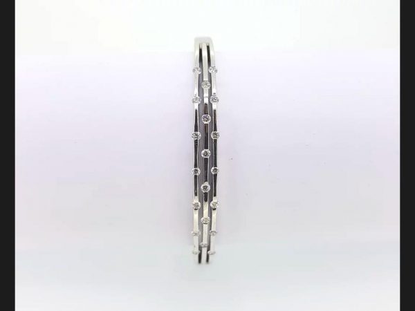 Diamond Bangle; Triple row of interspersed round cut diamonds set into an 18ct white gold bangle.