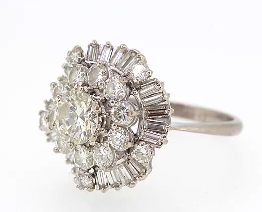 Vintage Diamond Cocktail Ring; central 1.80ct round cut diamond encircled by a double layer of 3.50cts round cut and baguette cut diamonds, 5.40 carat total, Circa 1960