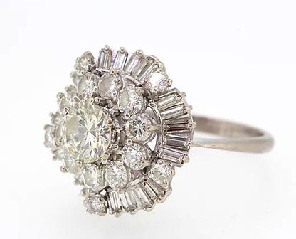 Vintage Diamond Cocktail Ring; central 1.80ct round cut diamond encircled by a double layer of 3.50cts round cut and baguette cut diamonds, 5.40 carat total, Circa 1960