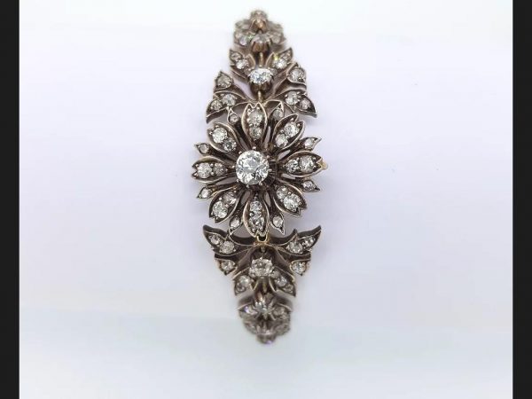 An antique Victorian diamond bracelet set with old cut diamonds in an intricate floral pattern, Set in silver and gold