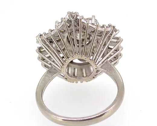 Vintage Diamond Cocktail Ring; central 1.80ct round cut diamond encircled by a double layer of 3.50cts round cut and baguette cut diamonds, 5.40 carat total, Circa 1960