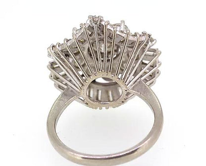 Vintage Diamond Cocktail Ring; central 1.80ct round cut diamond encircled by a double layer of 3.50cts round cut and baguette cut diamonds, 5.40 carat total, Circa 1960