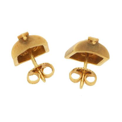 A pair of diamond masque stud earrings in gold. 