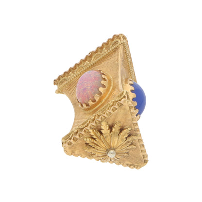A yellow gold Chinese lantern charm with a pink and blue stone on a white background