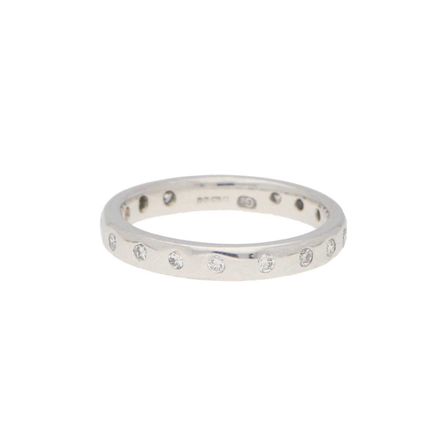 A white gold brilliant cut diamond eternity band, on a white background