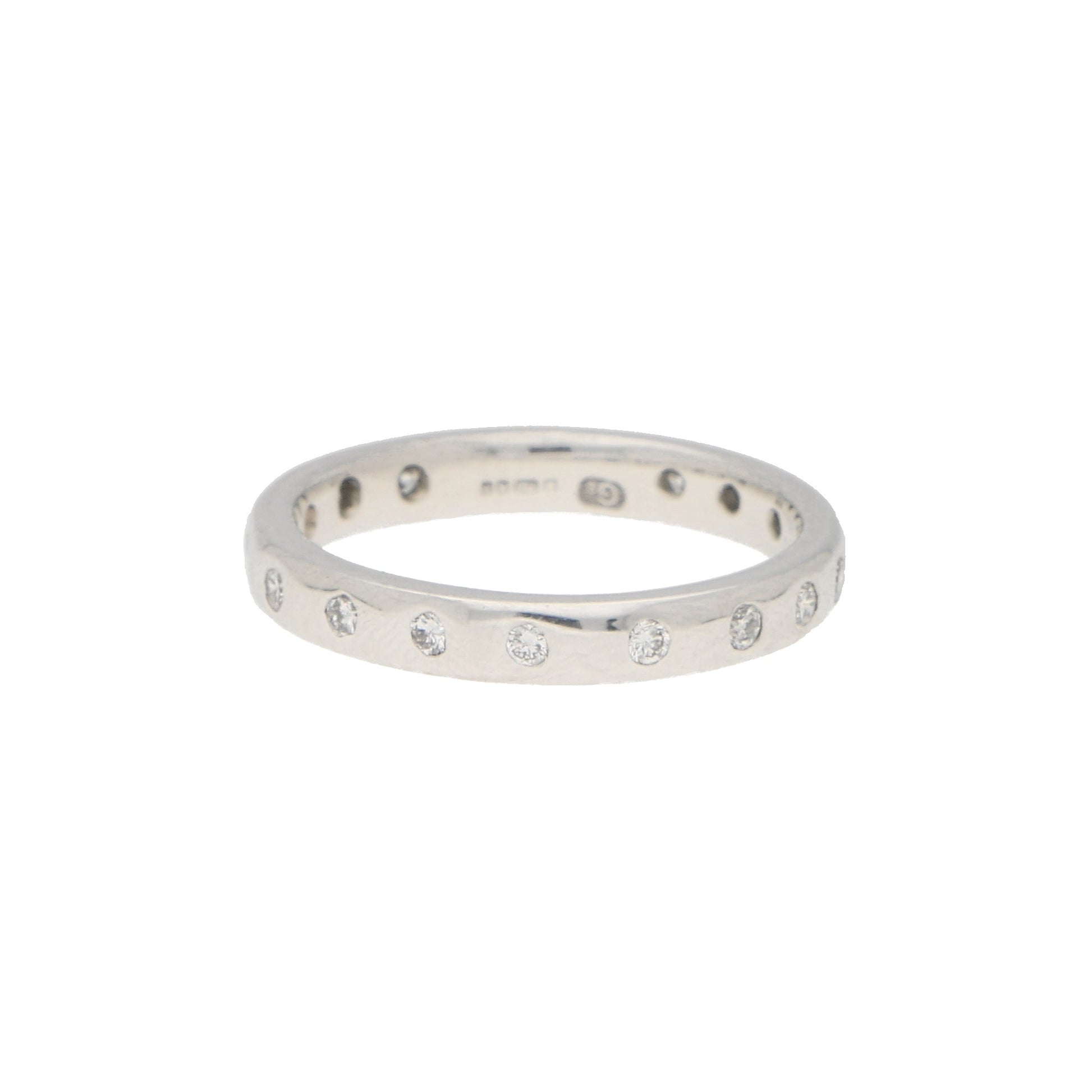 A white gold brilliant cut diamond eternity band, on a white background