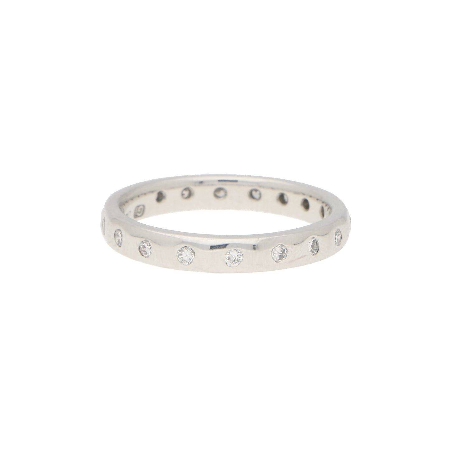 A white gold brilliant cut diamond eternity band, on a white background