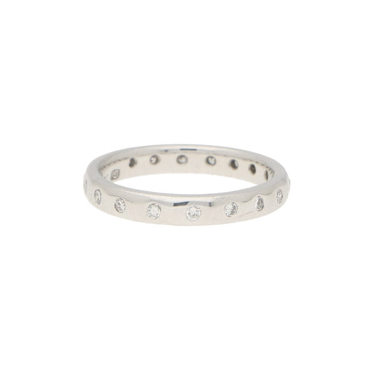 A white gold brilliant cut diamond eternity band, on a white background