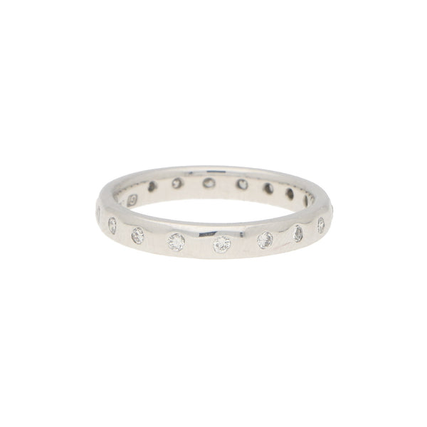 A white gold brilliant cut diamond eternity band, on a white background