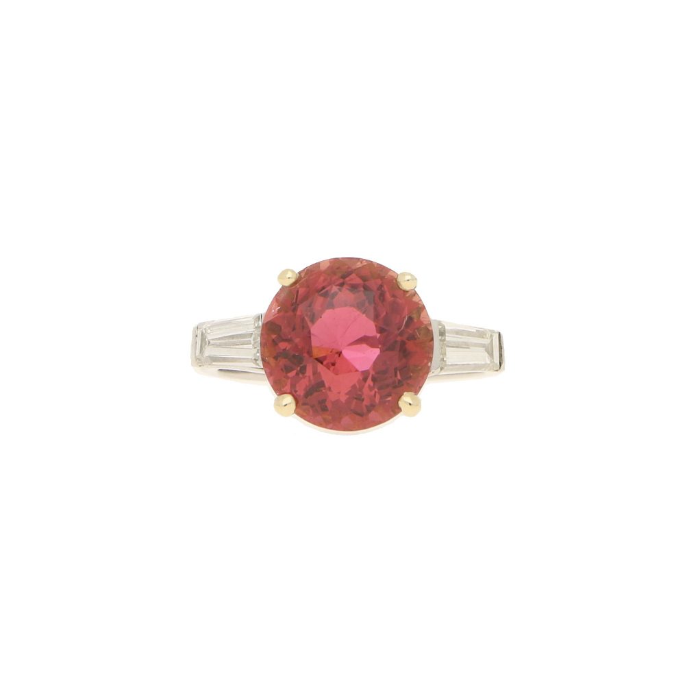 Pink Tourmaline and Diamond Engagement Ring; round faceted pink tourmaline four-claw set and flanked by two tapered baguette cut diamonds to the shoulders