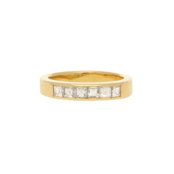 A yellow gold ring with six square diamonds, on a white background