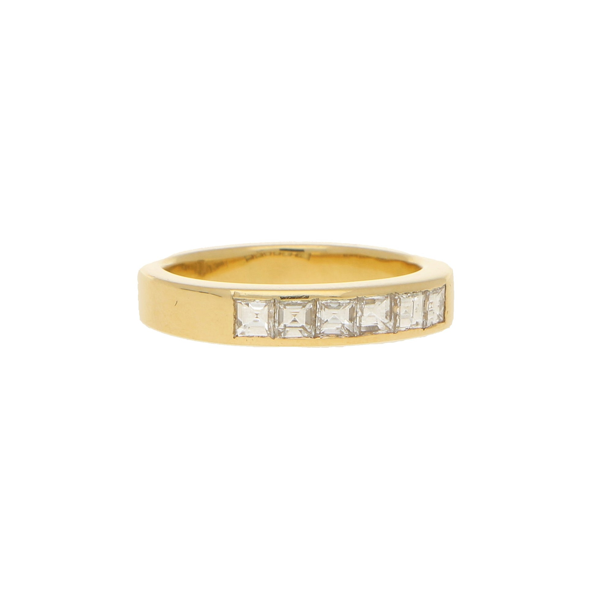 A yellow gold ring with six square diamonds, on a white background
