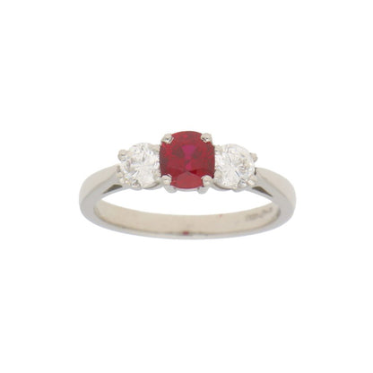 0.98ct Ruby and Diamond Trilogy Engagement Ring; central 0.98ct cushion-cut ruby flanked by 0.62cts brilliant-cut diamonds in 18ct white gold