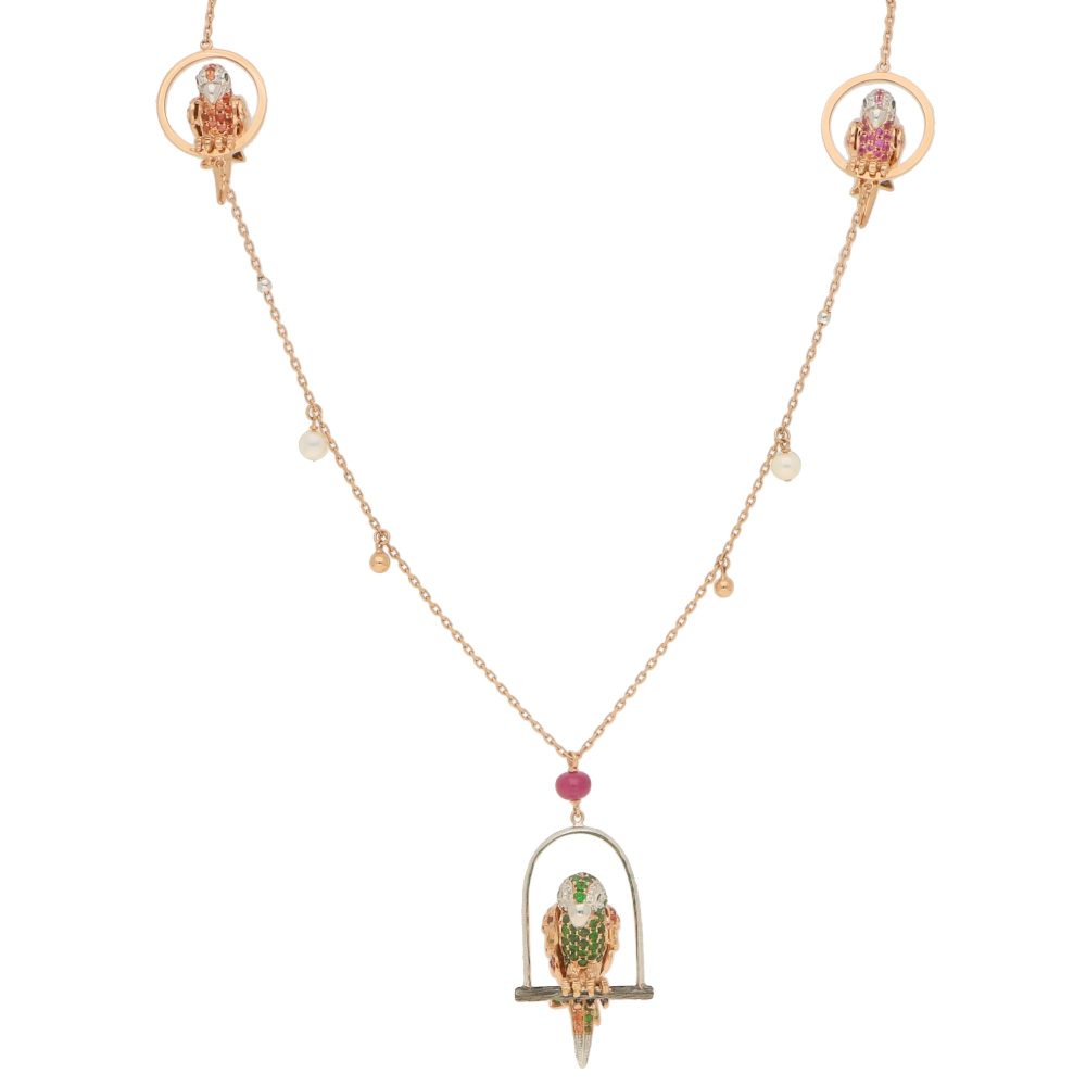 Tsavorite Garnet, Sapphire and Diamond Parrot Necklace; parrots set with orange, pink and yellow sapphires, tsavorite garnets and diamonds with ruby eye, in 18ct rose and white gold, on 26" 18ct rose gold station style chain interspersed with white gold round beads and rose gold beads and cultured pearls are suspended from the chain