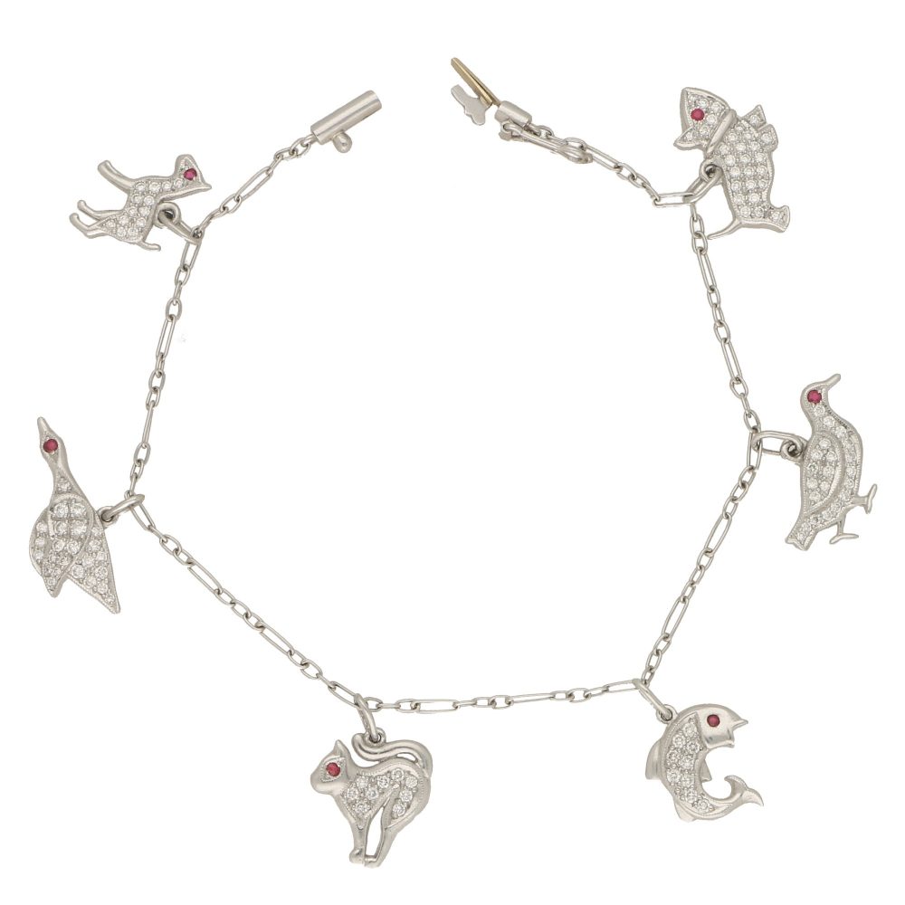 Vintage 1950s Animal Platinum Charm Bracelet with Diamonds and Rubies; six diamond-set charms with a ruby eye; a dog, grouse, fish, cat, duck and foul, 1.03 carats