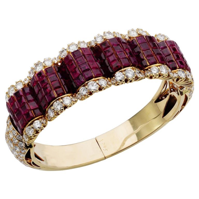 Ruby and diamond bangle in 14 carat gold.