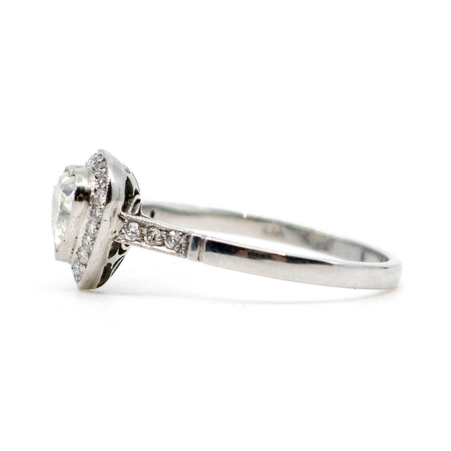 A heart shaped diamond cluster ring in platinum, with diamond shoulders