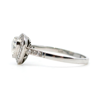 A heart shaped diamond cluster ring in platinum, with diamond shoulders