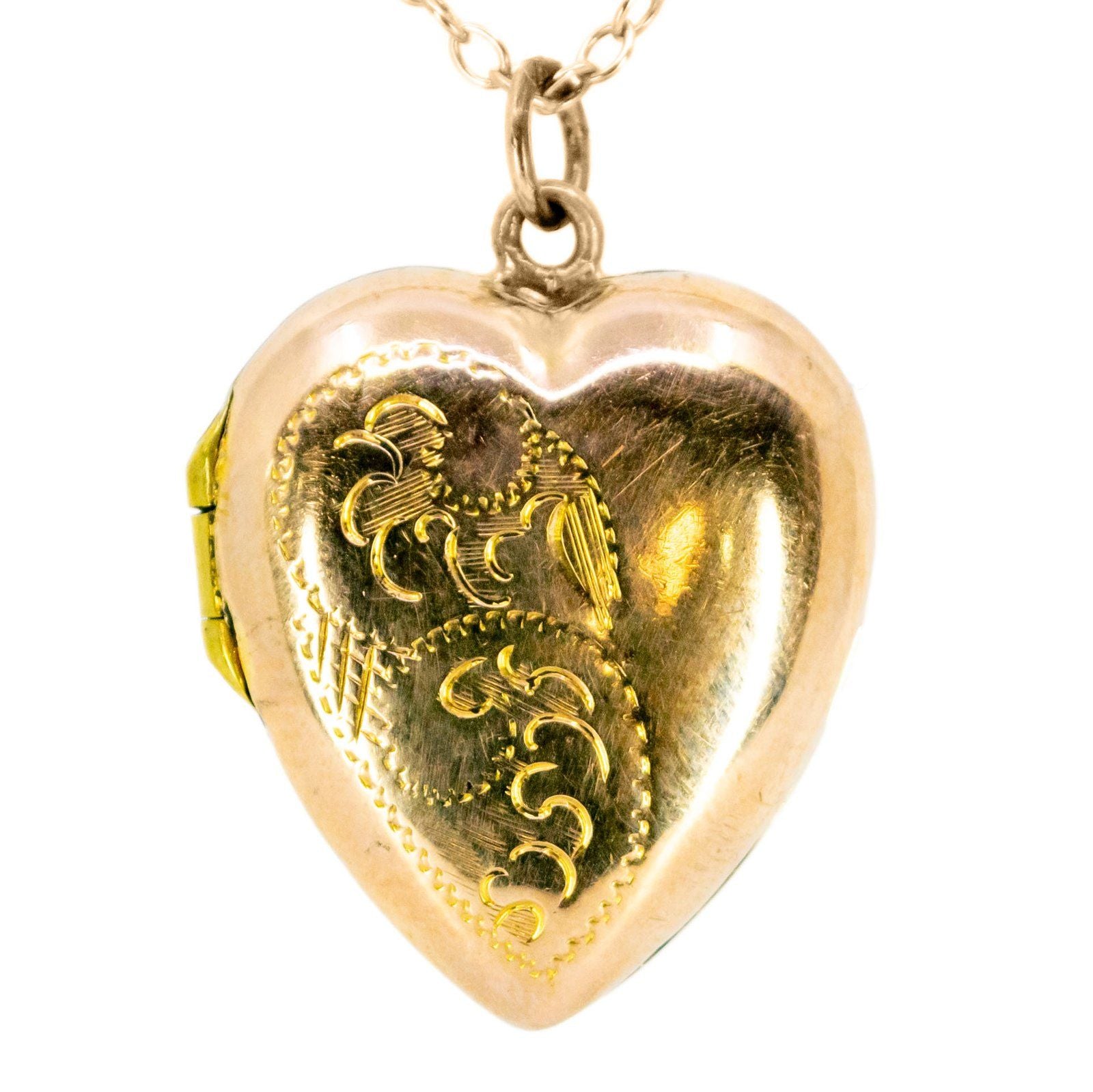 A yellow gold heart shaped locket, with a chain