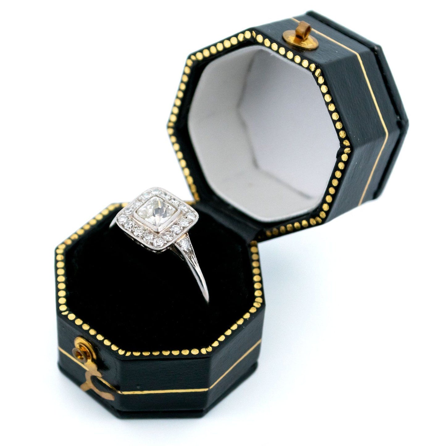 A square shaped diamond cluster ring in platinum, in a ring box