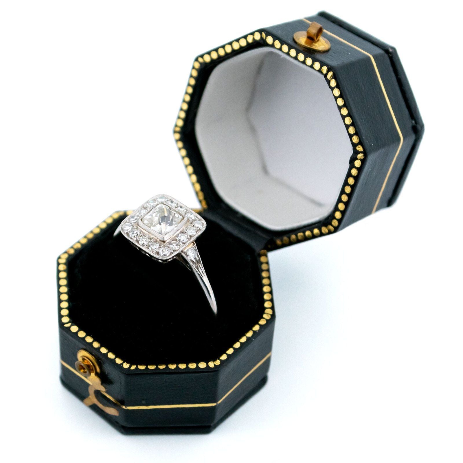 A square shaped diamond cluster ring in platinum, in a ring box