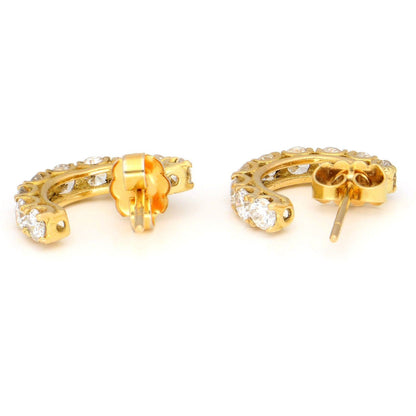 A pair of brilliant cut diamond half hoop earrings in yellow gold
