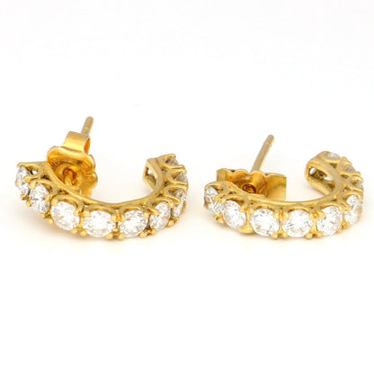 A pair of brilliant cut diamond half hoop earrings in yellow gold