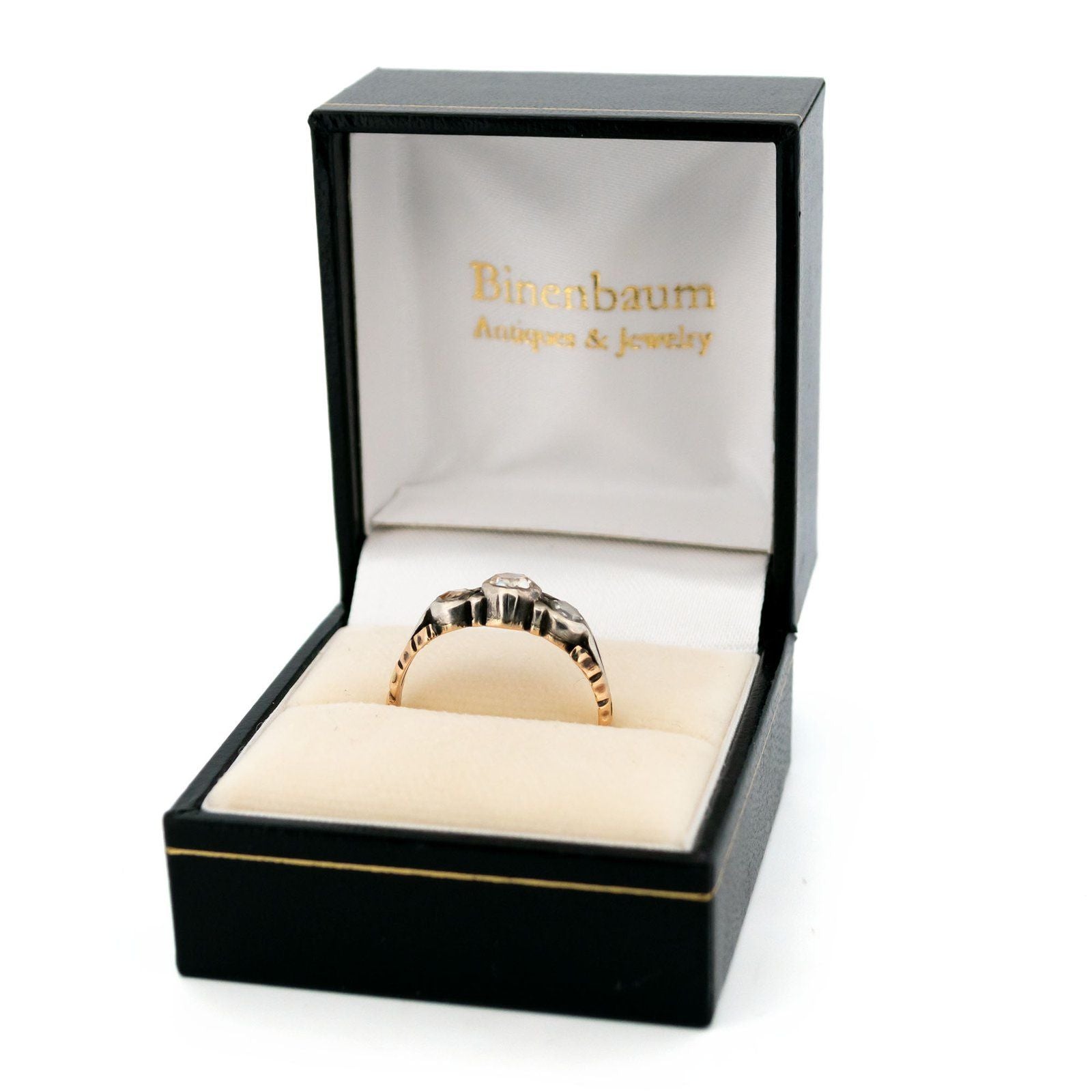 A yellow gold and silver rose cut diamond three stone ring, in a ring box