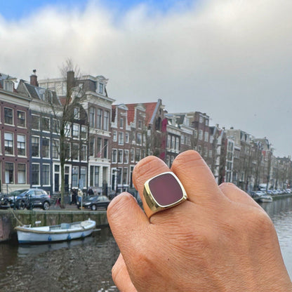 A carnelian signet ring in yellow gold, modelled on a hand