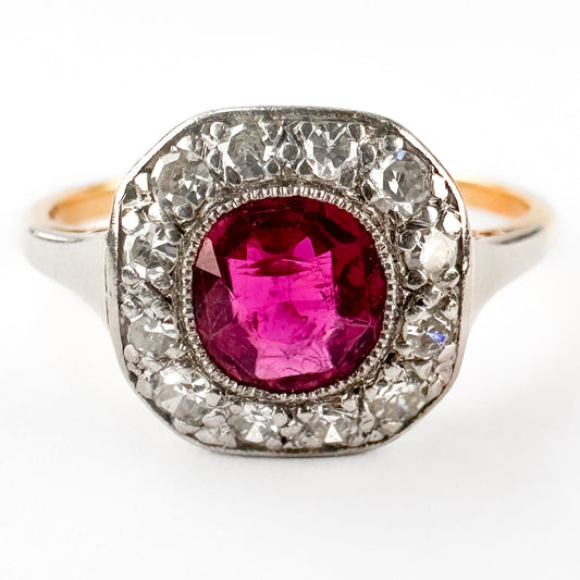 A ruby and diamond cushion shaped cluster ring in yellow gold and platinum