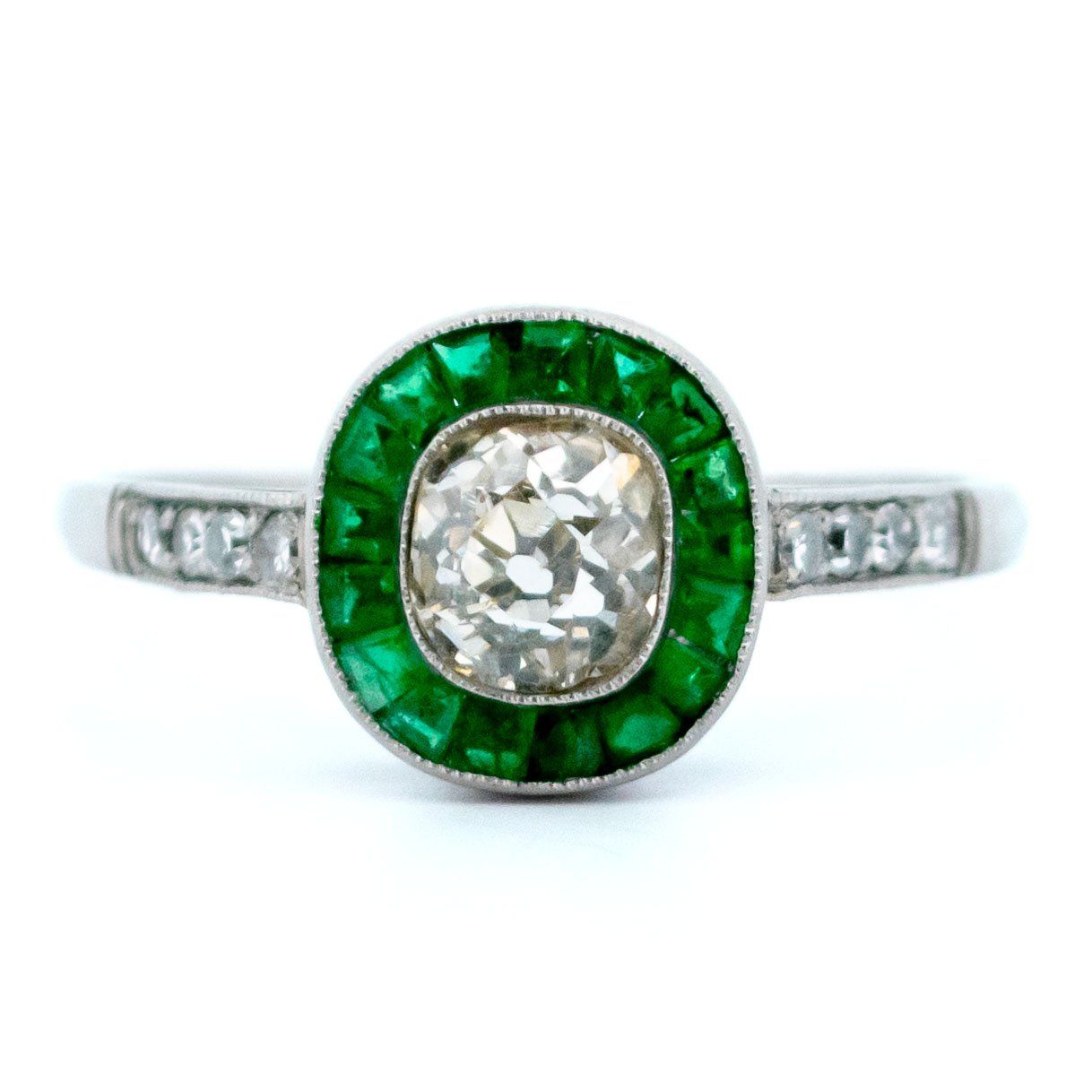 An emerald and diamond halo target cluster ring in platinum
