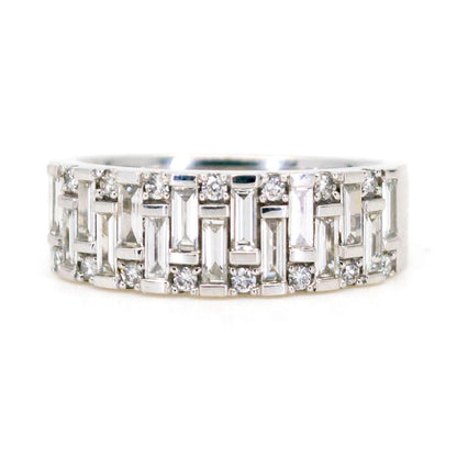 A baguette cut and brilliant cut diamond band ring in white gold