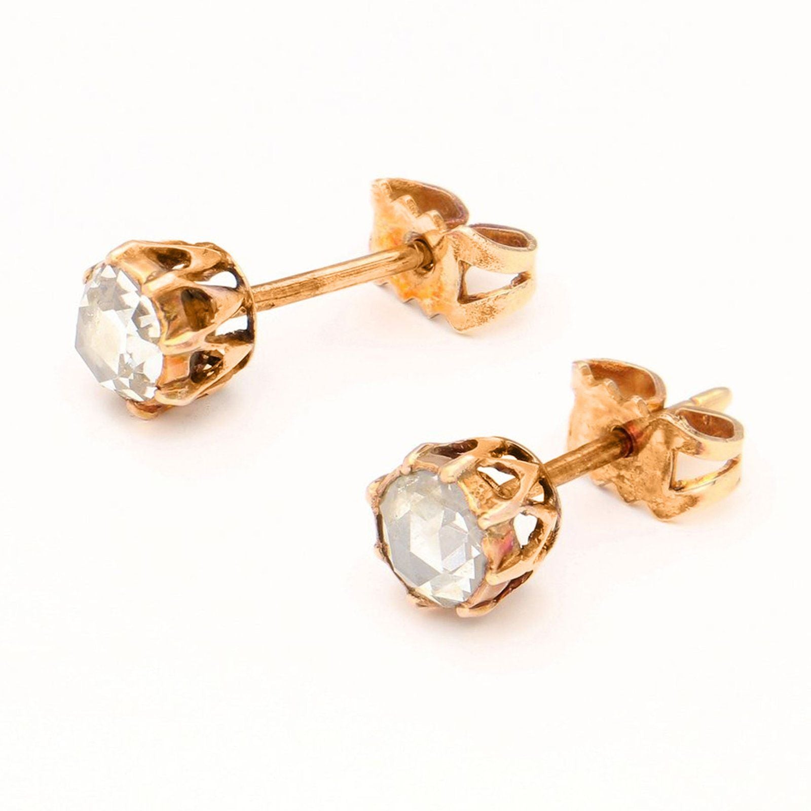 A yellow gold pair of solitaire rose cut diamond stud earrings
