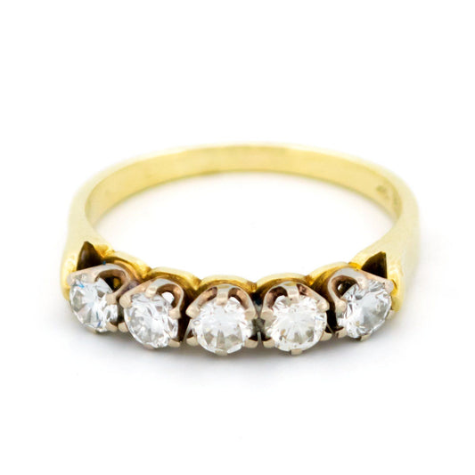 A five stone diamond ring in yellow and white gold