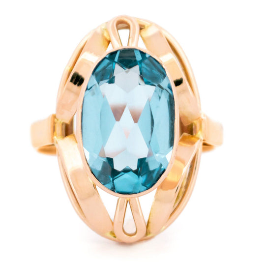 An oval cut aquamarine dress ring in yellow gold