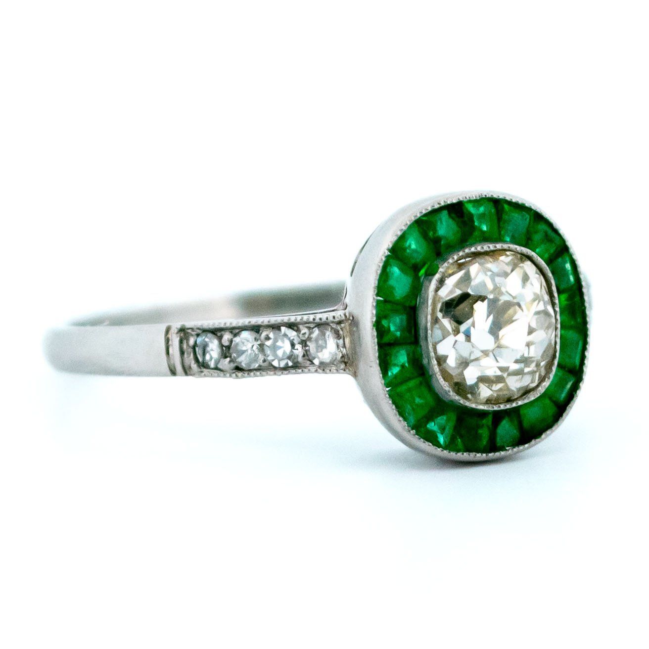 An emerald and diamond halo target cluster ring in platinum