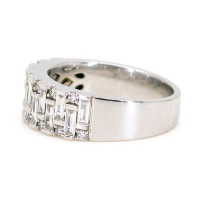 A baguette cut and brilliant cut diamond band ring in white gold
