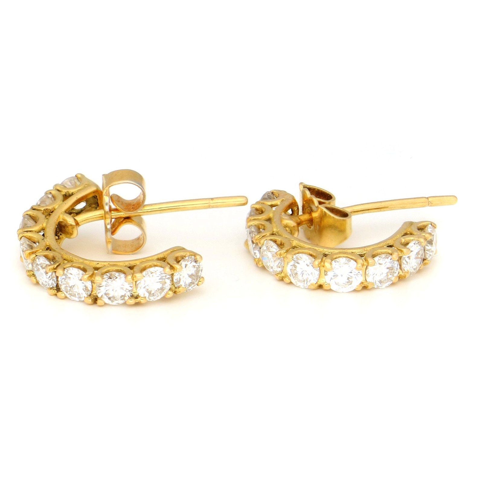 A pair of brilliant cut diamond half hoop earrings in yellow gold