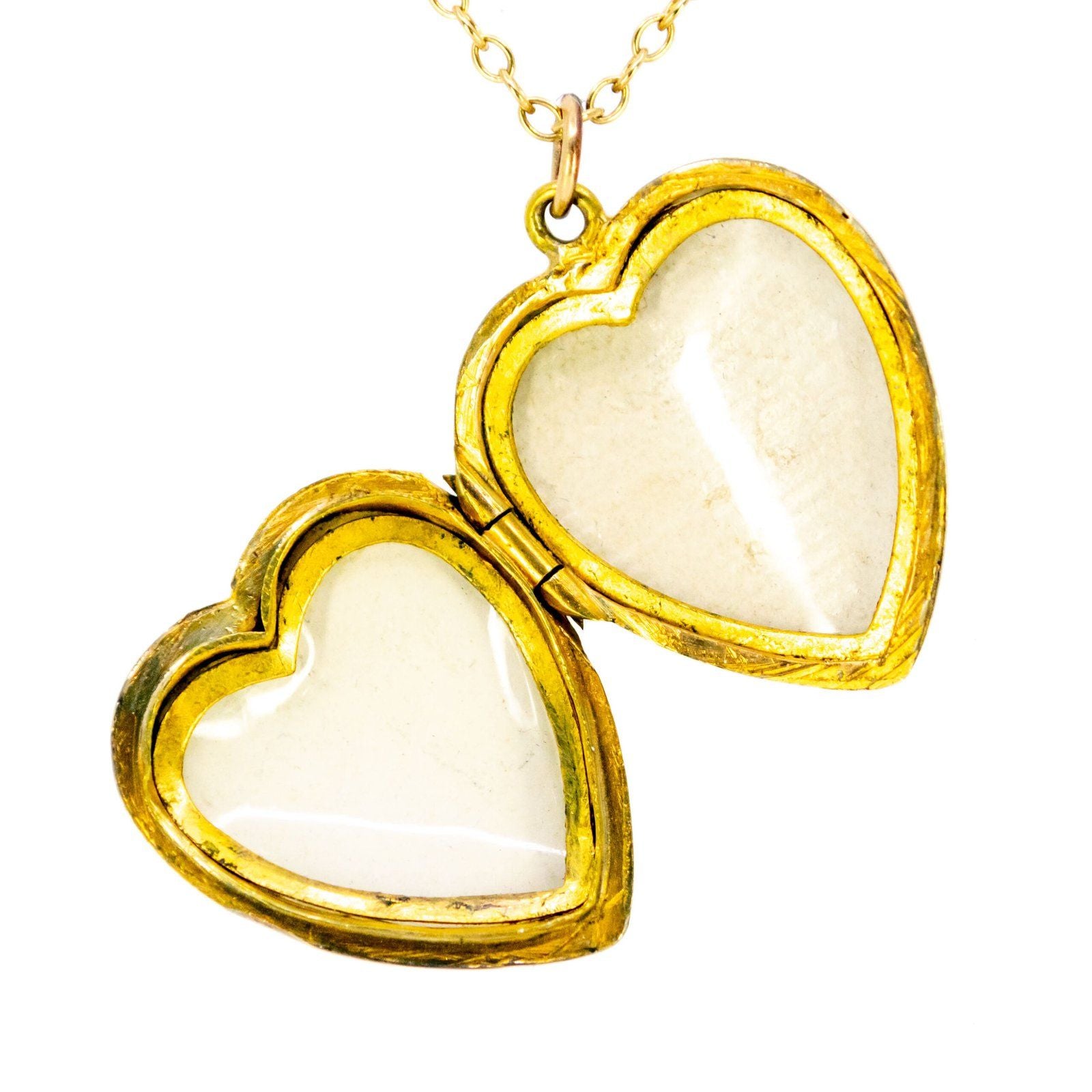 A yellow gold heart shaped locket, with a chain