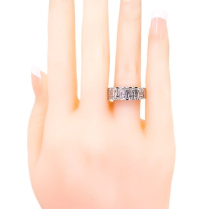 A baguette cut and brilliant cut diamond band ring in white gold, modelled on a hand